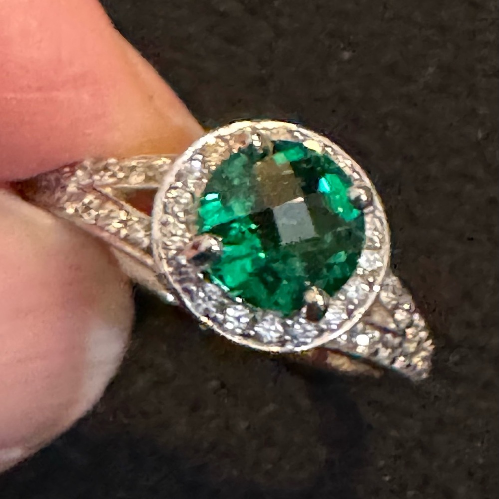 Sterling silver emerald ring with accents.
